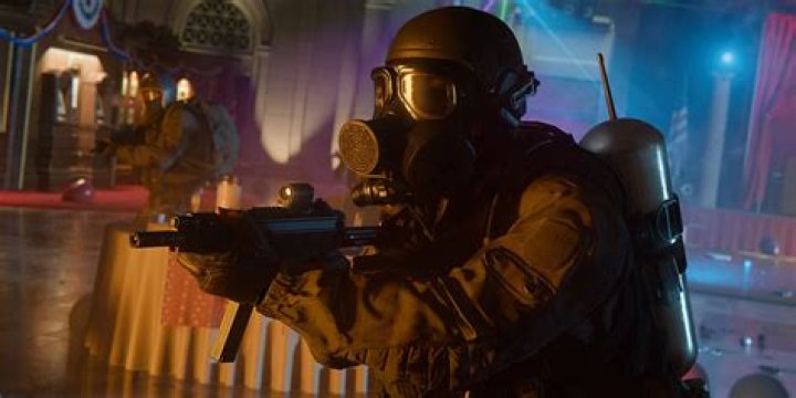 A player aims a submachine gun at an opponent inside a burning office building in a screenshot from Call of Duty: Modern Warfare 2