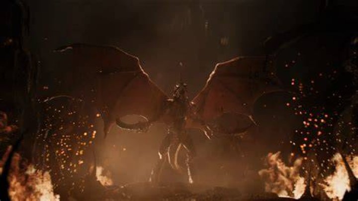 A Tyranid roars, extending its wings and alien limbs in a trailer for Warhammer 40,000&rsquo;s 10th edition. The tyranid is a fearsome beast, surrounded by fire and ash.